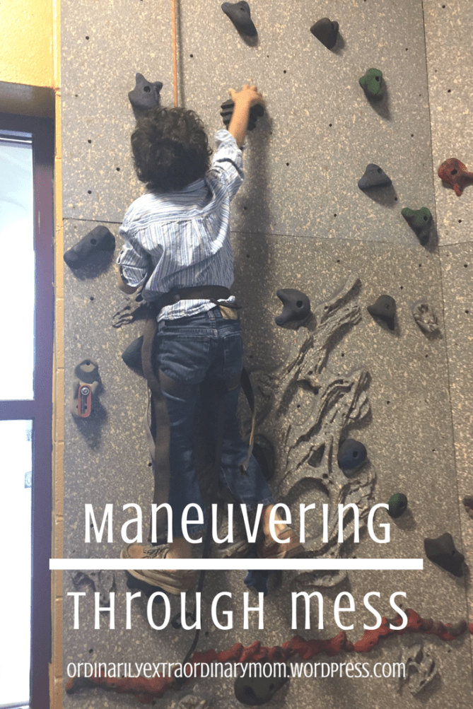 Small child conquering his fears and climbing rockwall.