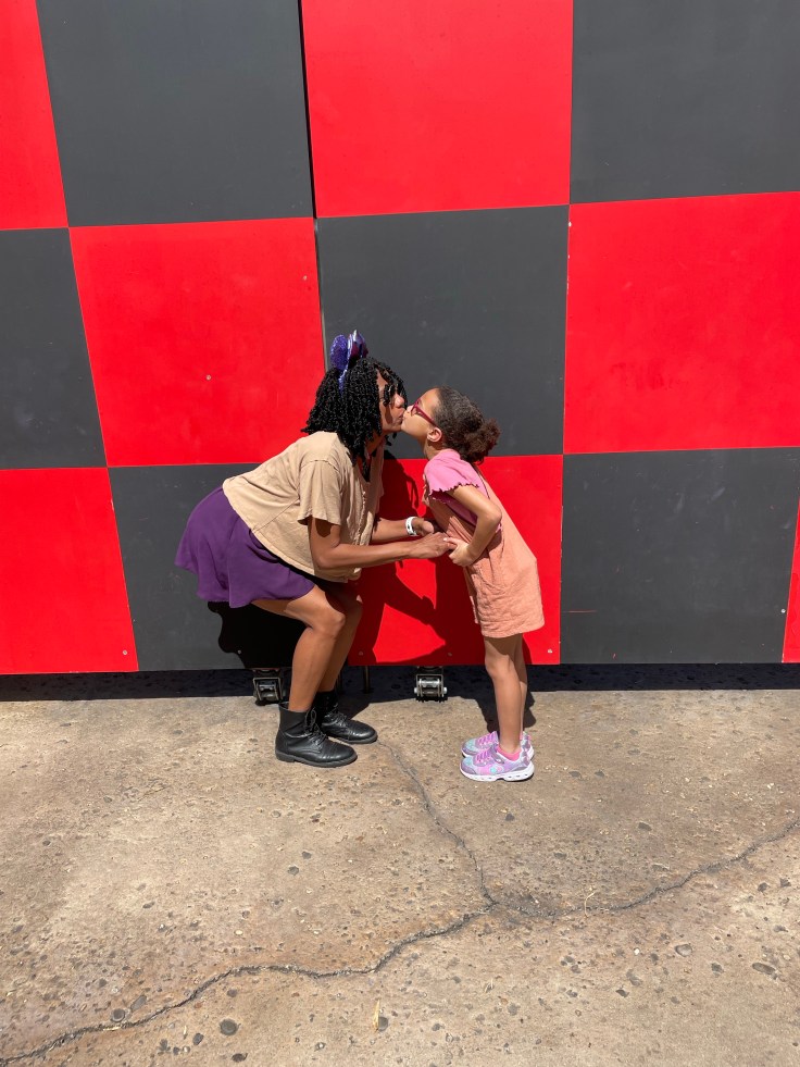 Disney World Photo Spots - Checker Wall at the exit of Toy Story Mania | ordinarilyextraordinarymom #disneyworldphotos #disneyphotos #disneyphotospots #disneyphotoideas #disneyphotoideaskids